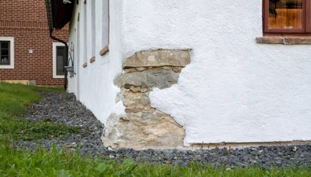 Naturkalk-Handputz an der Fassade eines Altbaus mit freigelegtem Bruchsteinmauerwerk an der Hausecke